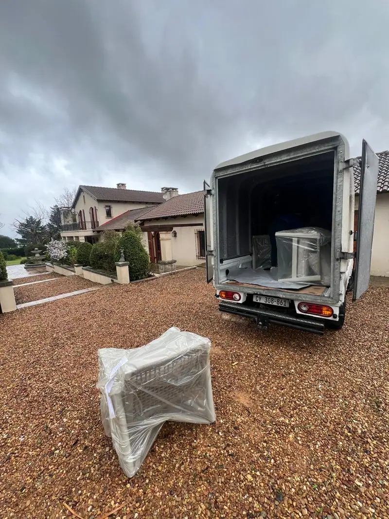 Truck unloading a wrapped chair at a customer's home