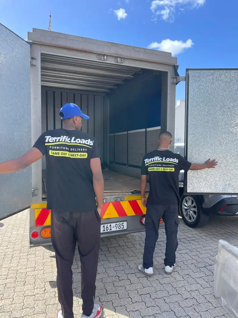 Two team members in Terrific Loads shirts opening the doors of a delivery truck